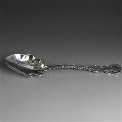 Late Victorian silver serving spoon, with lobed bowl and scrolling foliate decoration to h...