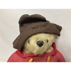 Pair of Paddington Bear teddies with amber eyes, the first example having a brown felt hat, red coat and blue PB boots with original label; the second having a grey felt hat, blue coat and blue Dunlop boots, tallest H51cm 