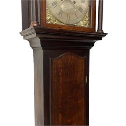 Thomas Hutchinson of Leeds - 18th century 8-day oak longcase clock with as broken arched  pediment and moulded cornice, with a conforming hood door flanked by plain turned pilasters with gesso capitals,  long trunk door with a wavy top on a square plinth with a raised panel, brass dial with cast spandrels,  engraved silvered dial centre and chapter ring with Roman numerals, five minute Arabic's and minute track, with pierced steel hands, seconds pointer,  arched calendar aperture and silvered boss engraved with the makers name to the break arch, dial pinned to a rack striking two train movement with a recoil anchor escapement. With weights and pendulum. Thomas Hutchinson is recorded as working in Leeds from 1760-90.