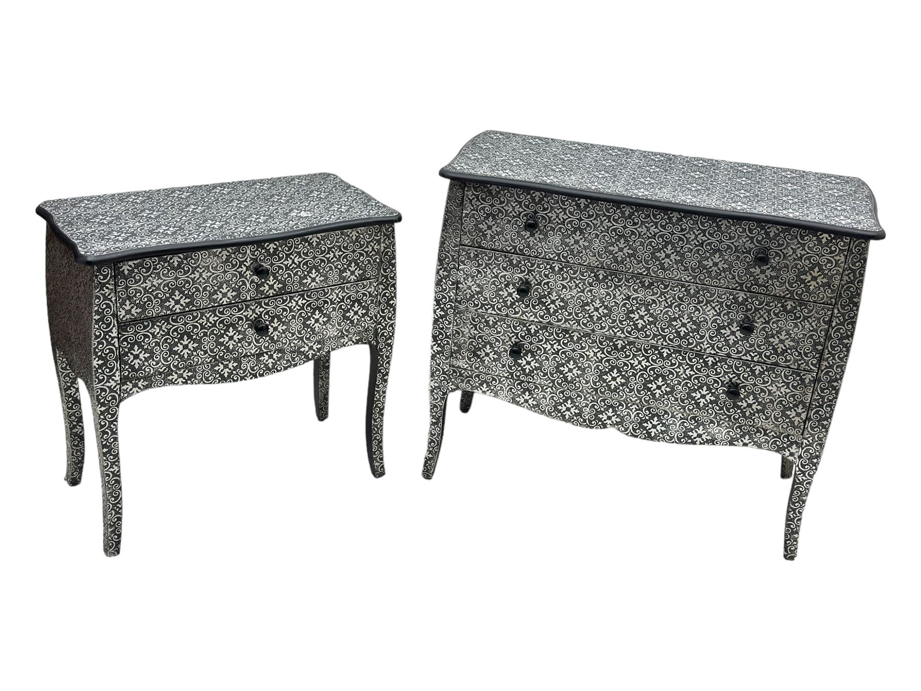 Contemporary black lacquered metal-clad chest, embossed with silver floral scrollwork, shaped rectangular top over three drawers, on cabriole supports (W89cm, D40cm, H79cm); matching two drawer chest (W68cm, D35cm, H67cm)