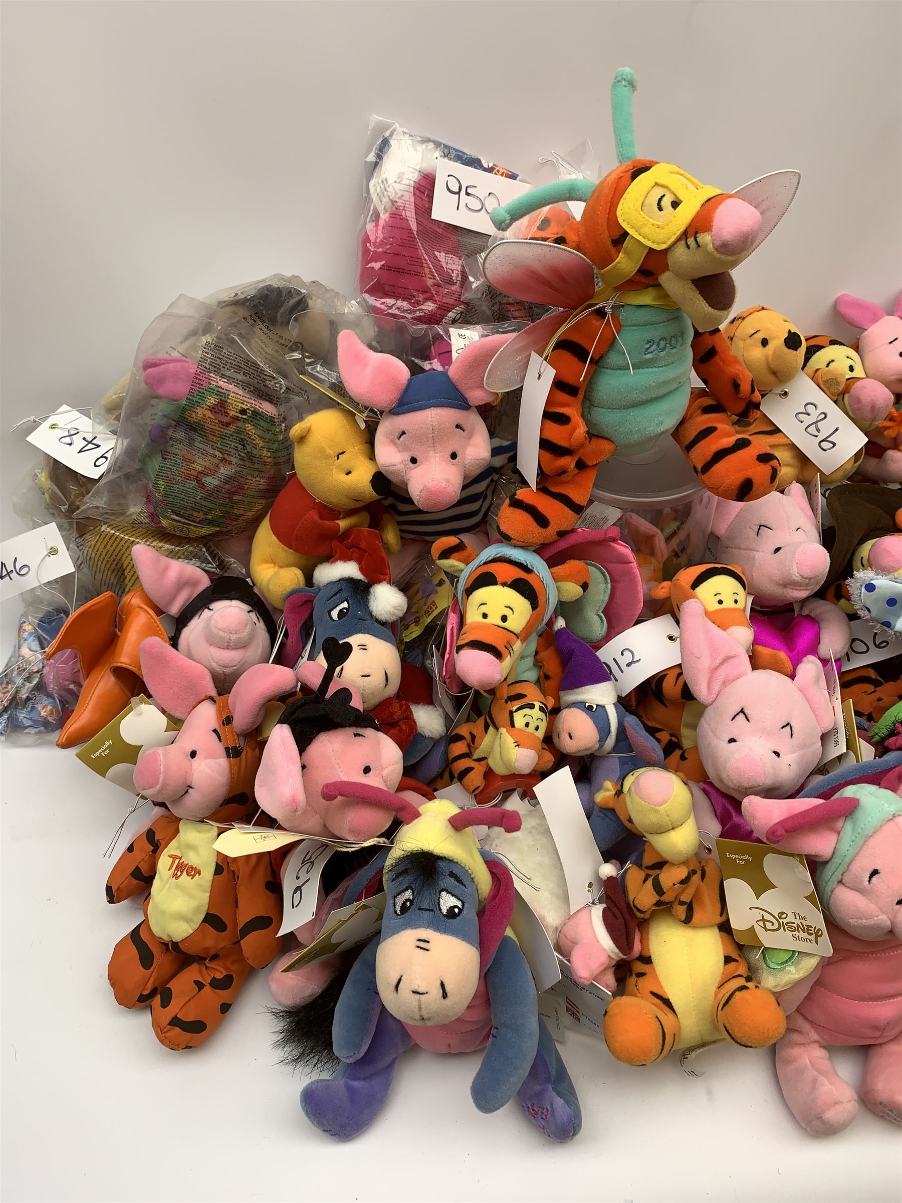 Over forty Walt Disney character soft toys including Tigger Pirate, Xmas Tree, Cowboy, Butterfly, Easter Rabbit etc, Eeyore Santa, Butterfly, Pirate etc, Piglet Lovebug, Valentine, Snowball etc; together with seventeen Garfield the Cat soft toys in various character costume including Skier, Graduate, Aviator, car rear window stickers etc