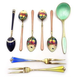  Two Norwegian silver-gilt and enamel serving forks by David Anderson, four Norwegian silver-gilt and enamel coffee spoons, with still life of fruit decoration by Henry James Hulbert, import marks, London 1925, one other by same maker and one other similar spoon stamped Frigast sterling Denmark (8)  