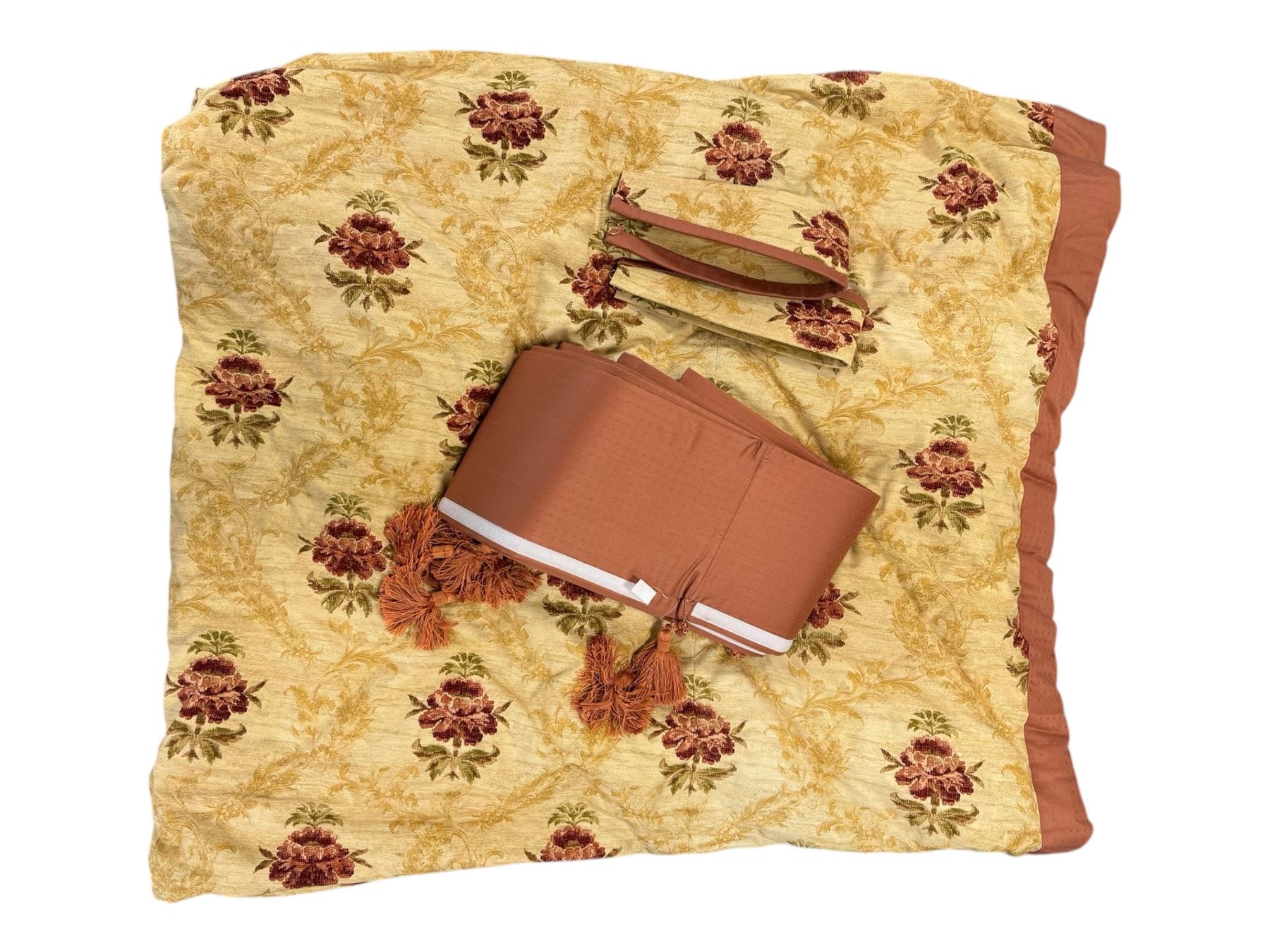 Mid-20th century quilted bedspread and matching valance, the bedspread displaying a warm gold floral pattern with burgundy highlights, complemented by a terracotta fabric trim, together with coordinating terracotta valance with tassels
