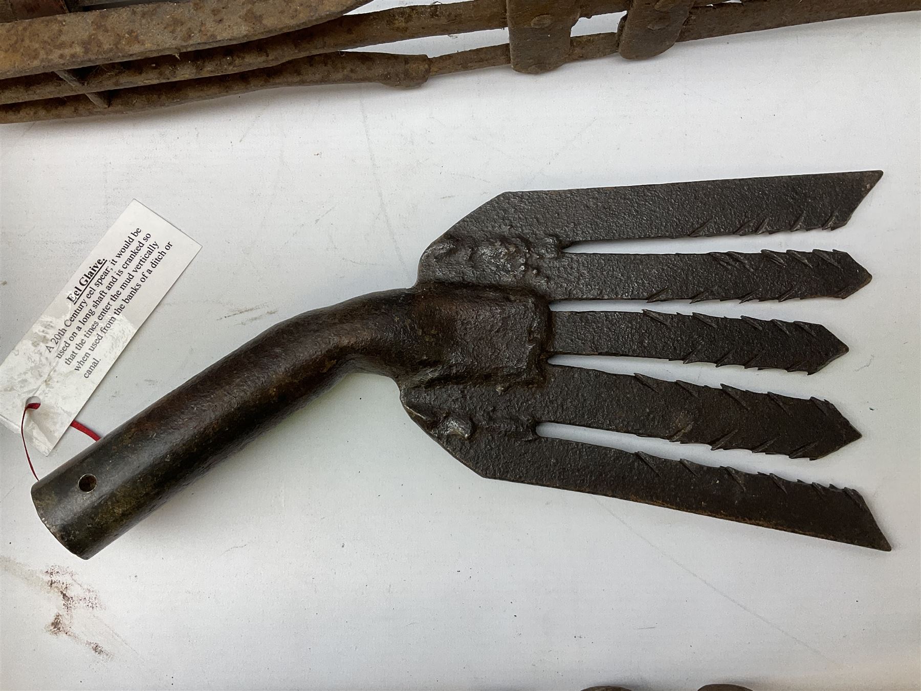 Blue and red painted gas powered bird / pest scarer, bearing label 'Exid bird & pest scarer, imported by C.R.E.A.C.O Hadleigh, Essex', , copper and brass Cymag gas hand pump, three eel spears and a set of badger tongs. Auctioneer's Note: These traps are sold as artefacts for ornamental purposes only as the use of some of them is illegal.