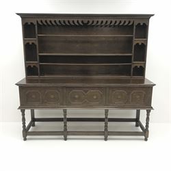Early 20th century oak dresser, raised single tier plate rack, projecting cornice, three drawers, baluster supports joined by square stretchers