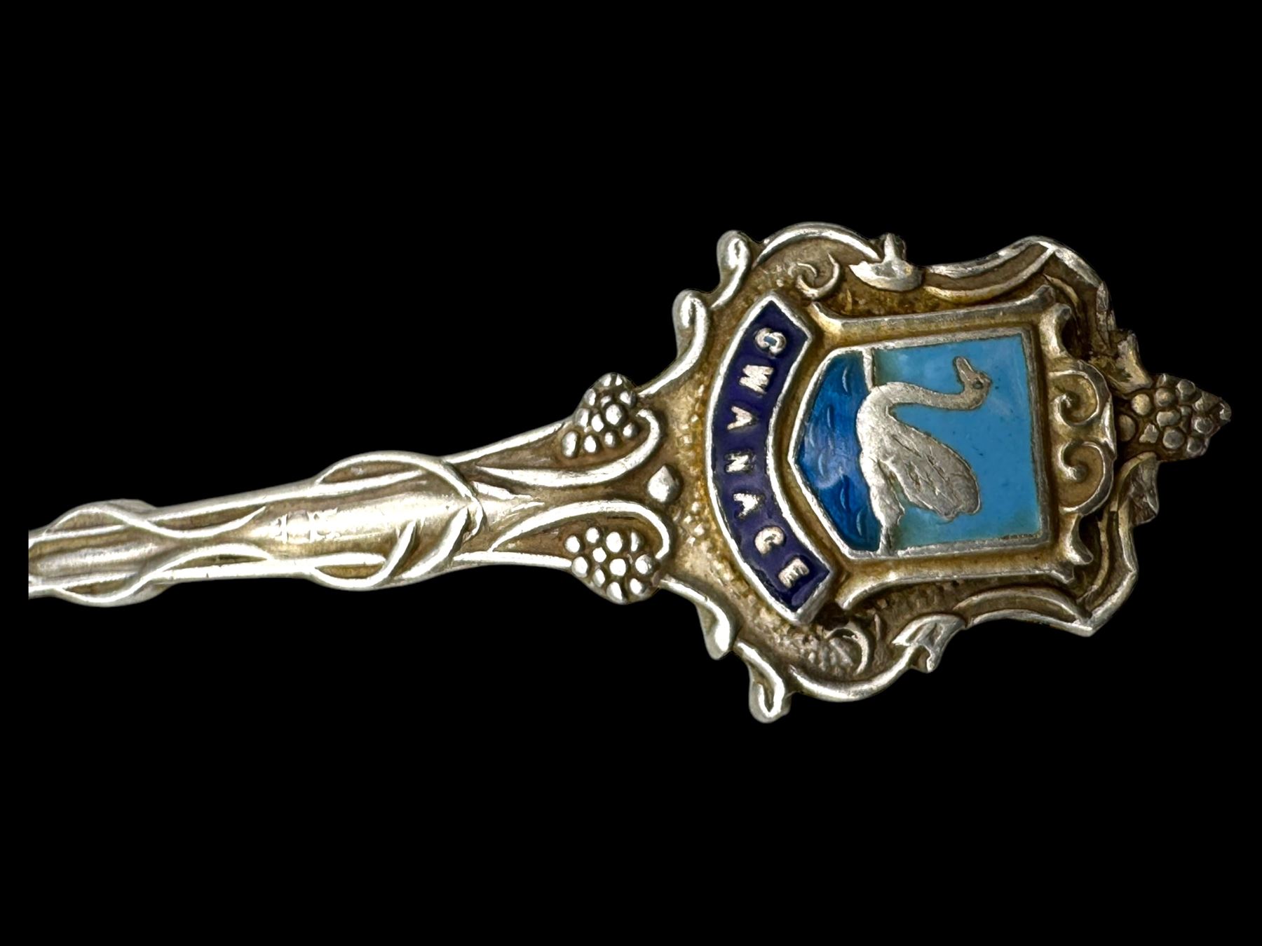 Three silver decanter labels and a collection of silver and silver plated cutlery