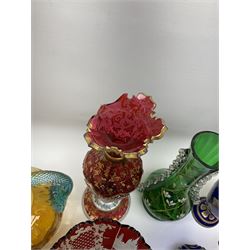 A group of 19th century and later coloured glassware, to include a number of English and Continental ruby glass souvenir examples, and a selection of Bohemian glass, including a vase with floral painted overlaid panels, H30.5cm, a pair of amber glass candlesticks engraved with deer, H24.5cm, a similarly decorated vase, etc. 
