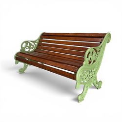 Pair of Victorian design cast iron and slatted wooden garden benches, the ornate pierced end supports of scrolled form, the pierced acanthus leaves interspersed with trailing flowerheads, with tassels to the front, raised on splayed feet, the supports in pale sage green painted finish