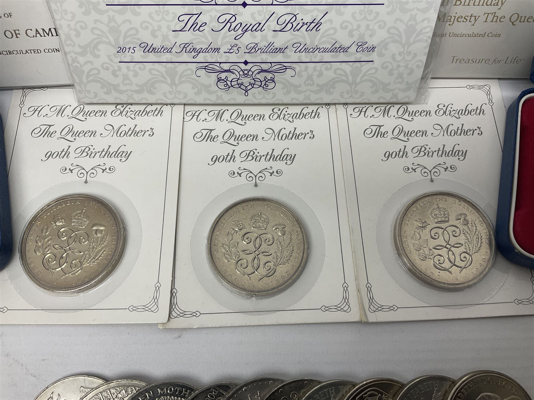 Queen Elizabeth II 1977 silver crown and 1980 silver crown, both cased with certificates, Bailiwick of Guernsey 1978 silver crown cased without certificate, three United Kingdom brilliant uncirculated five pound coins in card folders and twelve other five pound coins