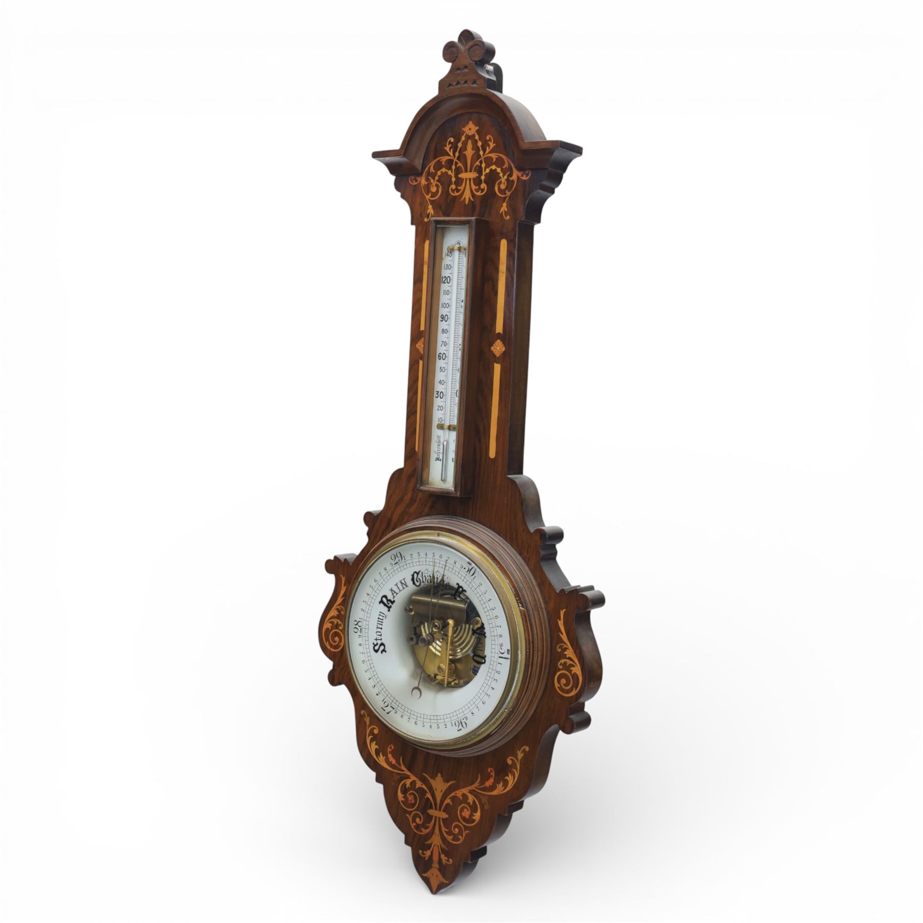 Victorian inlaid rosewood aneroid wall barometer, the circular glass-printed dial with brass bezel, with weather indications for Stormy, Rain, Change, Fair, and Very Dry, with enclosed aneroid movement beneath, shaped case with marquetry scrolls and foliate motifs surmounted by a thermometer with dual Fahrenheit and Centigrade scales, circa 1890-1900