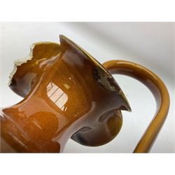 Linthorpe pottery vase with crimped rim and ovoid body, Linthorpe jug with high loop handle and crimped spout, a pair of candlesticks with a green, brown glaze and other similar pottery 