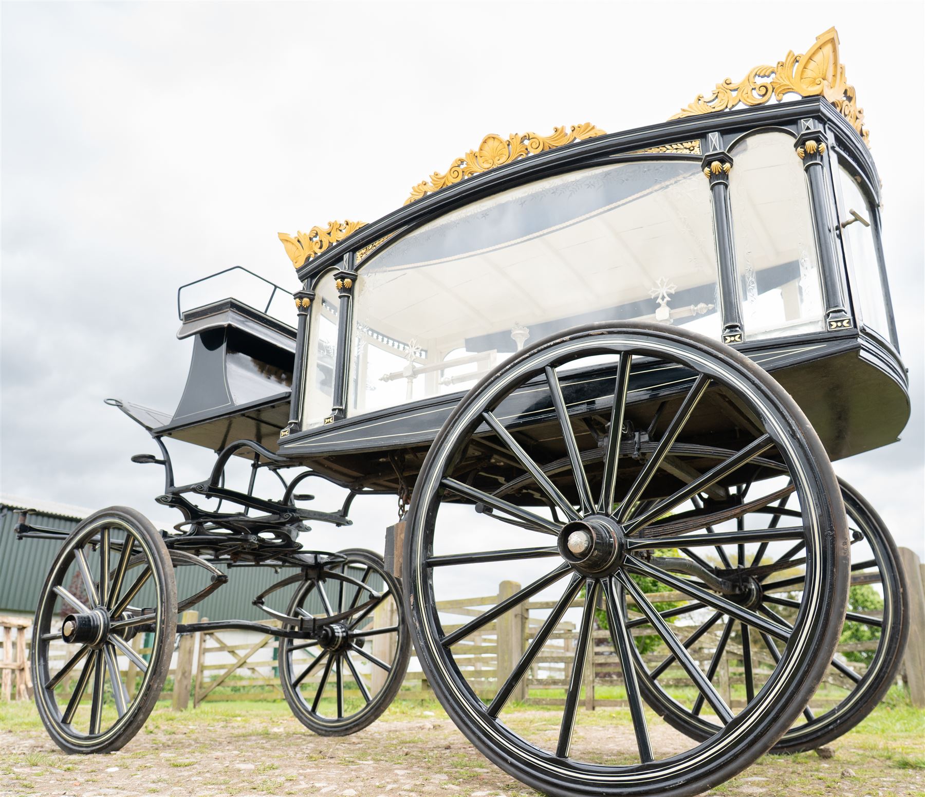 Victorian Glass Hearse

A black painted four wheeled horse drawn glass hearse with extensively glazed coffin compartment, etched glass side and end panels, decorative gilt cresting, gilt column capitals, white painted interior bier deck, metal coffin rails with cross finials, rear glazed access doors, external coachman's box seat for two, wooden spoked wheels the wheel hubs stamped 'The Economic Funeral Co', leaf spring suspension, underbody turntable steering and pole for driving with a pair of horses. The hearse has decorative painted lining throughout and an ornate black and gilt body with curved glass panels to the sides and rear.

Features

• Extensively glazed coffin compartment
• Etched glass side and end panels
• Decorative gilt cresting
• Gilt column capitals
• White painted interior bier deck
• Metal coffin rails with cross finials
• Rear glazed access doors
• External coachman's box seat
• Wooden spoked wheels
• Leaf spring suspension
• Underbody turntable steering
• Pole for driving with a pair of horses
• Decorative painted lining

Dimensions:
Overall length: 406 cm
Body length: 250 cm
Overall width: 190 cm
Body width: 115 cm
Height: 228 cm

Wheel Diameters:
Front wheels: 102 cm
Rear wheels: 133 cm

Seating

Coachman's box seat: 2