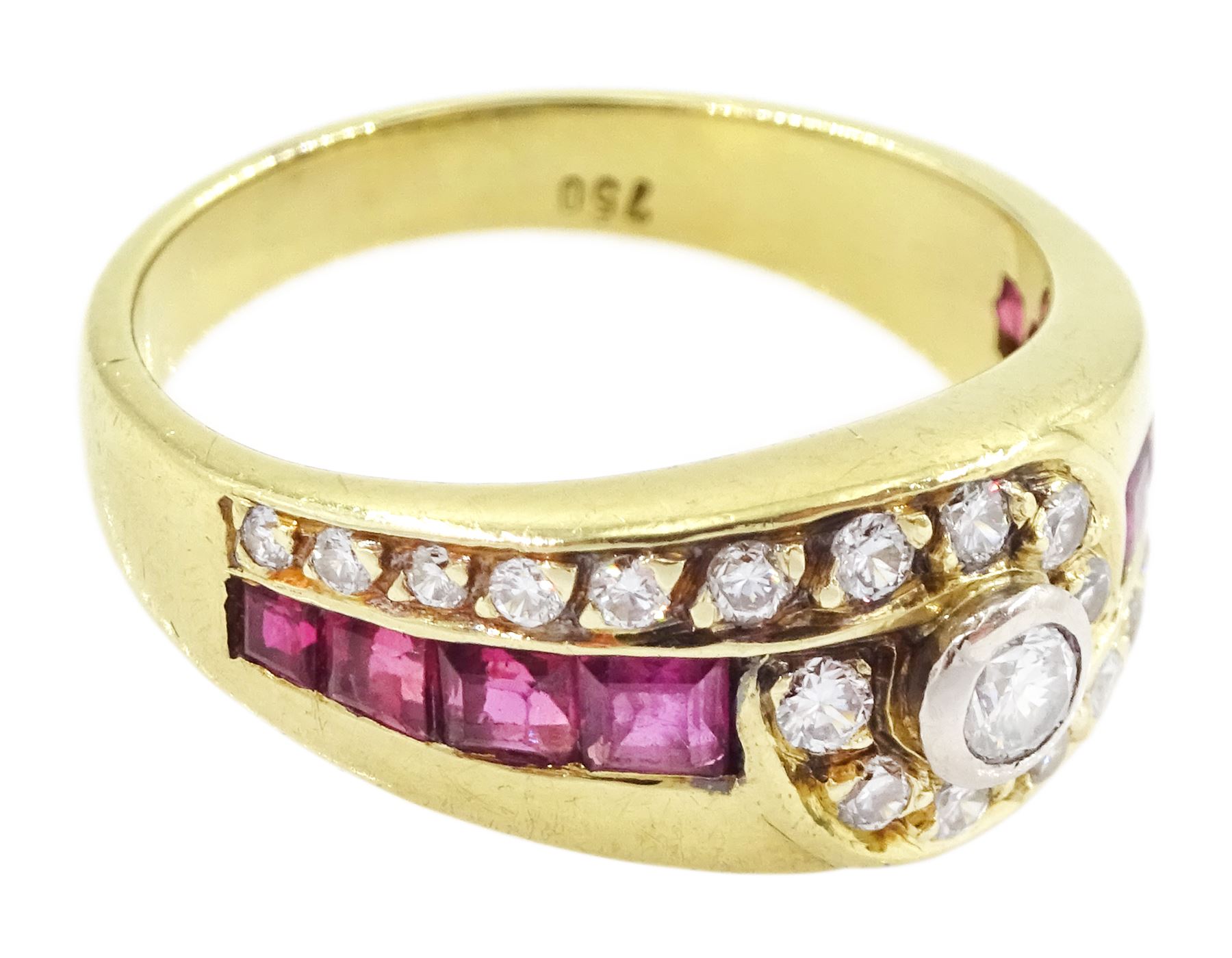 18ct gold diamond and ruby crossover ring, the principal round brilliant cut diamond of approx 0.10 carat, with graduating round brilliant cut diamond and calibre cut ruby shoulders, stamped 750