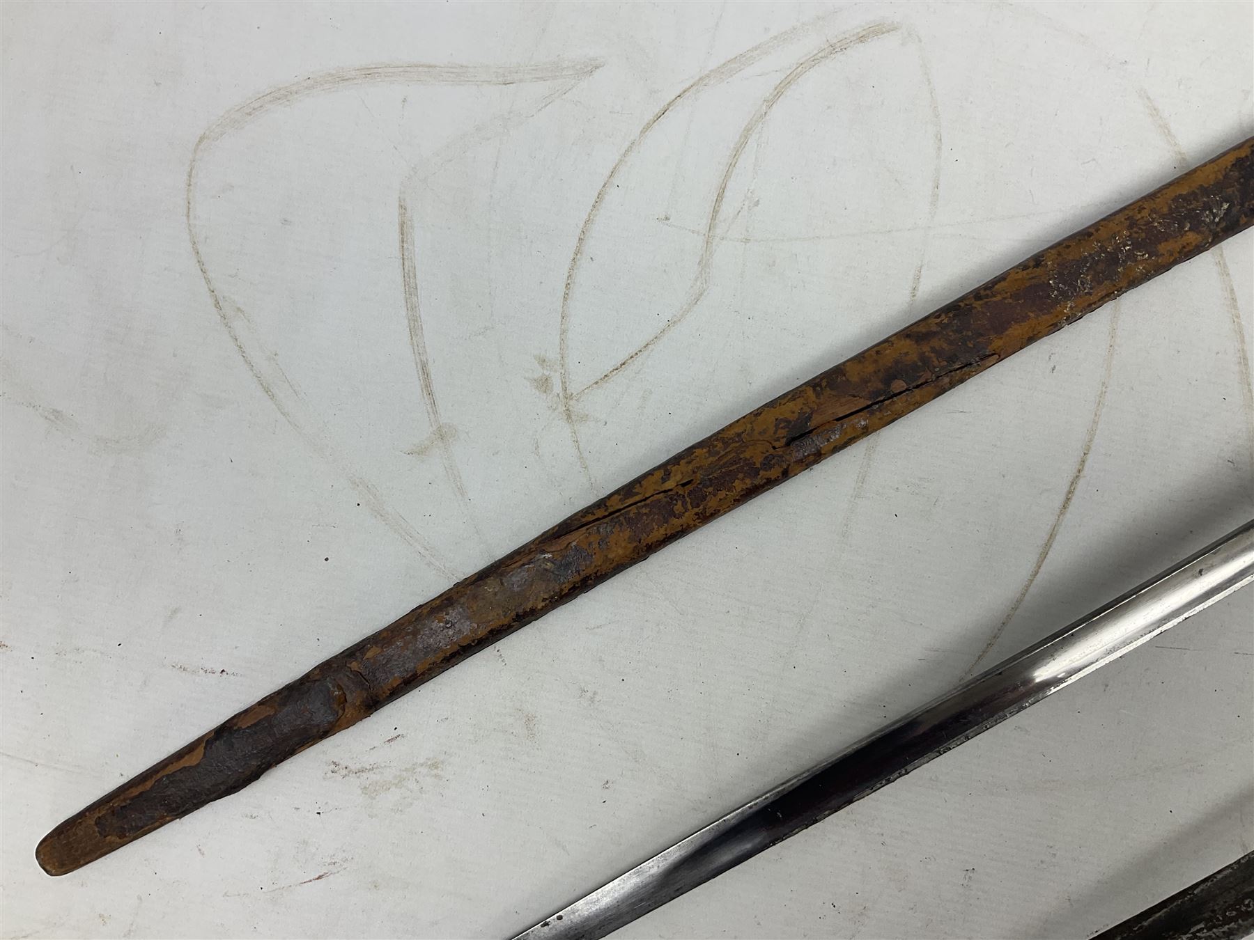 George V British Army 1897 pattern officers sword with plain 82cm fullered steel blade, pierced  basket hilt with George V cypher and wire bound leather grip with chequered backstrap; in leather covered field service scabbard L101cm overall; and another officer's sword in relic condition lacking scabbard (2)