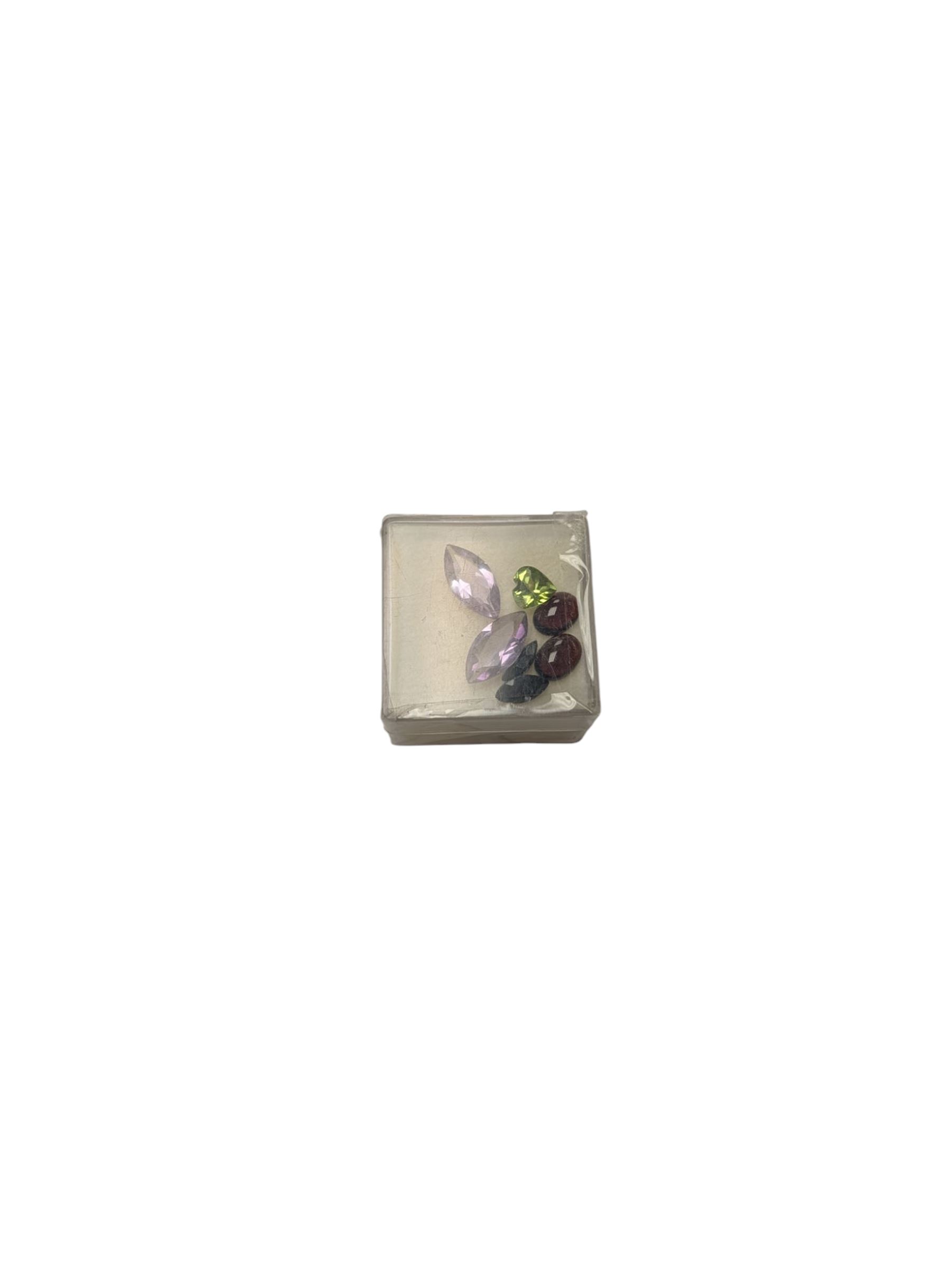 Loose gemstones, including two sapphires, two amethysts, two garnets and a peridot heart