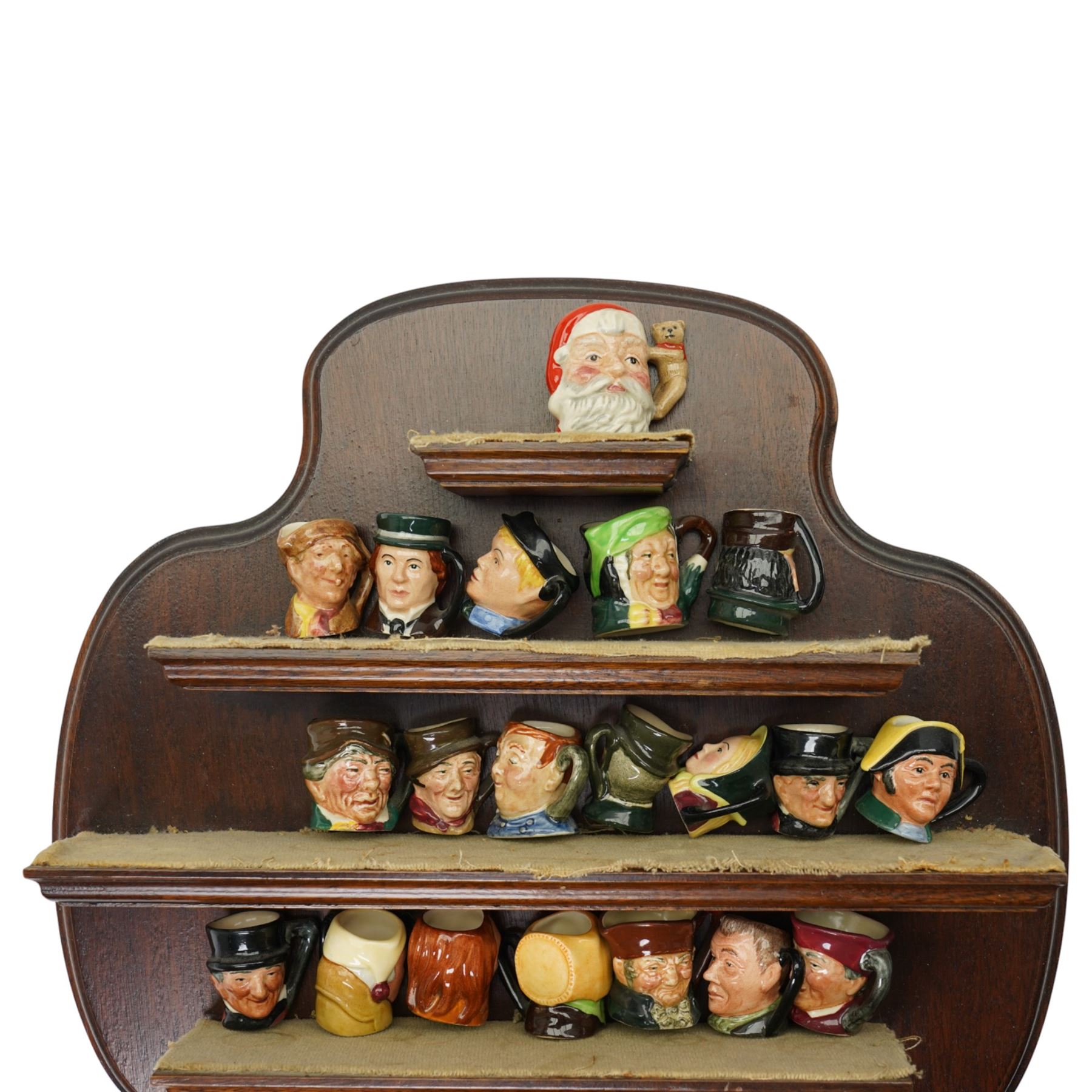 Collection of  forty two miniature Royal Doulton character jugs on three wall shelves, one inscribed Royal Doulton