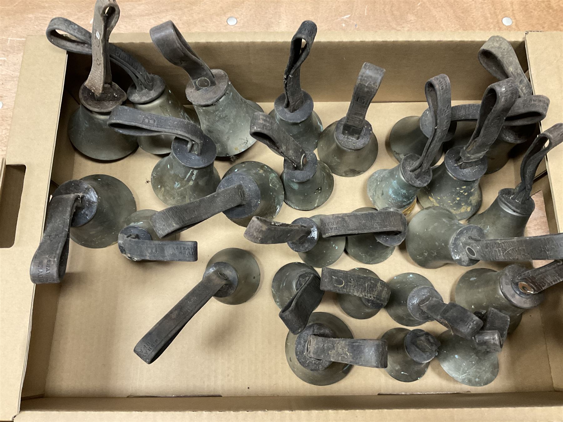 Collection of 44 late 19th century brass church/musical handbells with leather straps by James Shaw Brothers of Bradford and bells marked G.W. possibly cast by the George Welch bell foundry, London.
The number of bells and stated notation, some at different pitch, is as follows;
5 “C”, 4 “D”, 5 “E”, 4 “F”, 5 “G”, 5 “A”, 6 “B”.
3 “F#”, 4 “C#”,1 “Db”, 1 “G#”, 1”A#”.
Two of the bells are minus their clappers and one bell has no leather strap.
