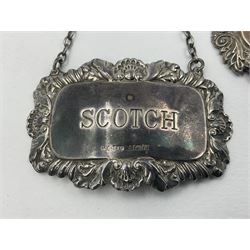 Five modern silver decanter labels, to include three similar Sherry and Brandy examples embossed with scrolls, two hallmarked C Robathan & Son, Birmingham 1989, and one hallmarked Laurence R Watson & Co, Birmingham 1987, together with a scotch example, hallmarked A Marston & Co, Birmingham 1970, and a larger sherry example, embossed with fruiting vines, hallmarked A Marston & Co, Birmingham 1993