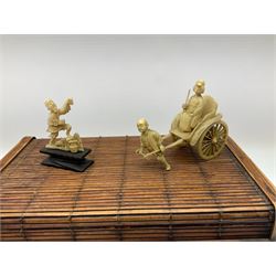 Bamboo box containing Japanese celluloid rickshaw group, small porcelain figure of a young girl playing cymbals; Japanese bamboo fan depicting Mount Fujiama; and various resin and bone items including bracelet, small lidded box, figures etc