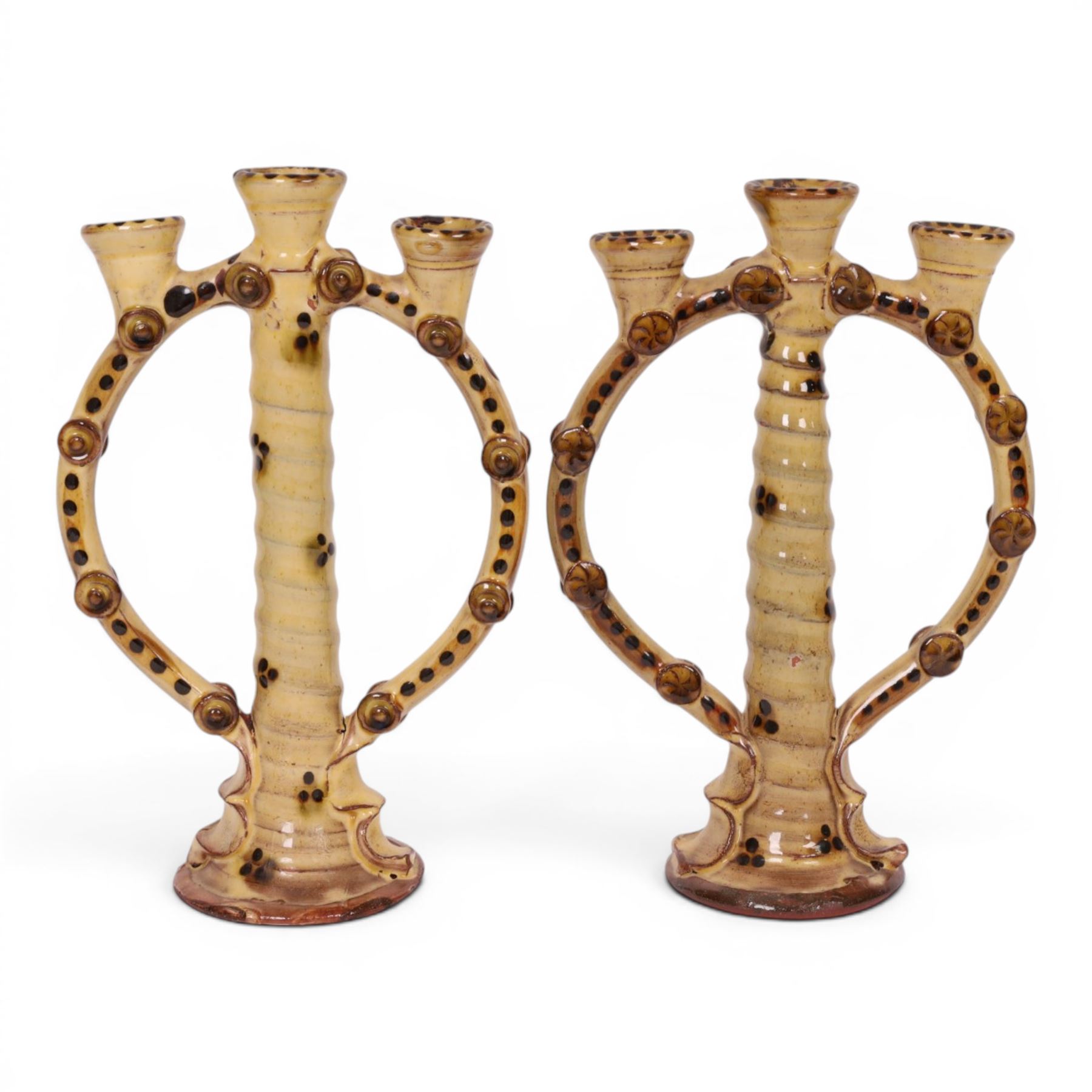 Pair of studio pottery candlesticks, with a central twisted column bordered by circular supports, H24cm 