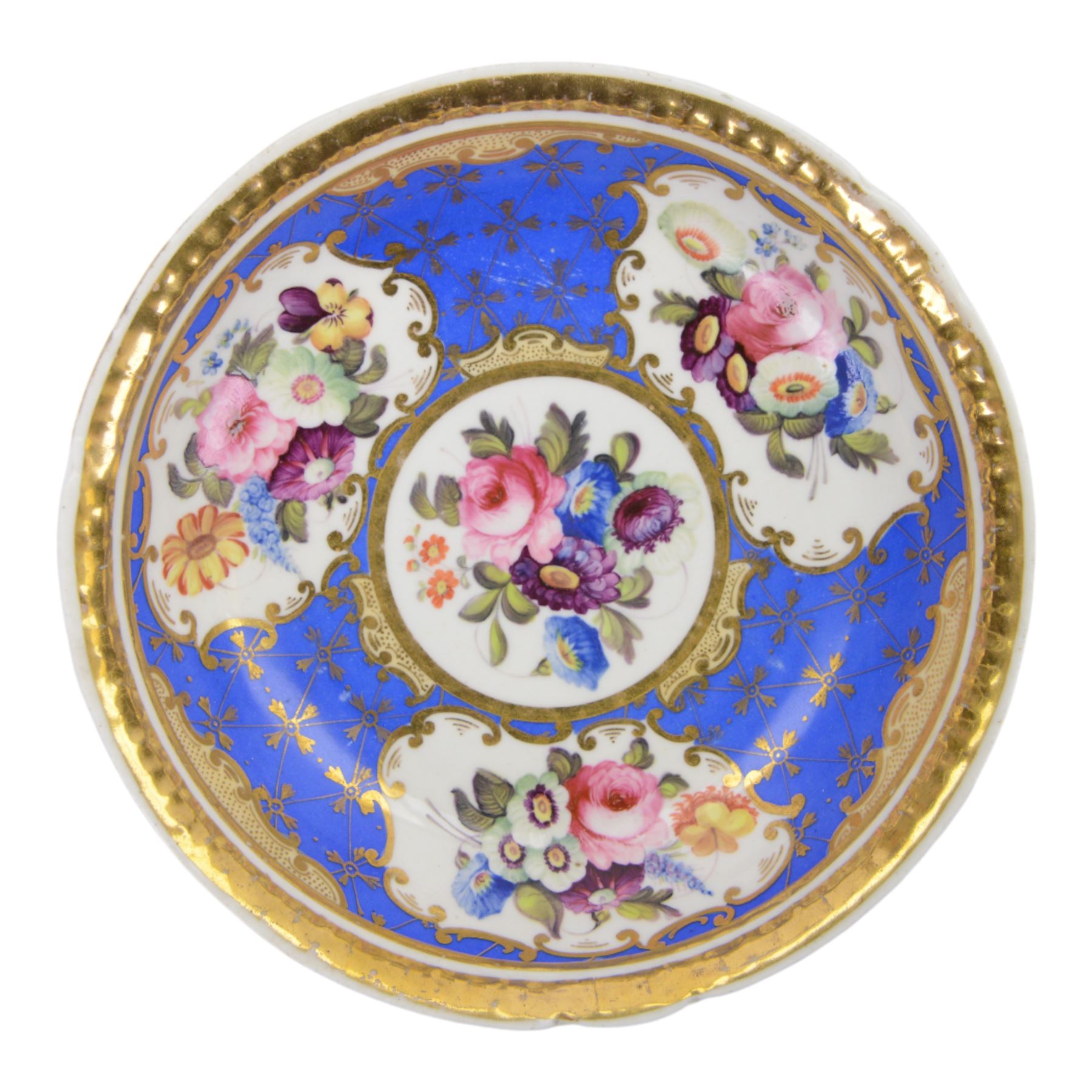 H&R Daniel trio, coffee cup, teacup and a saucer, circa 1825, Gadroon shape with D handle, painted with reserves of fine foliate sprays against a blue ground with gilt trellis detail, coffee cup including handle H8.5cm, saucer D14cm