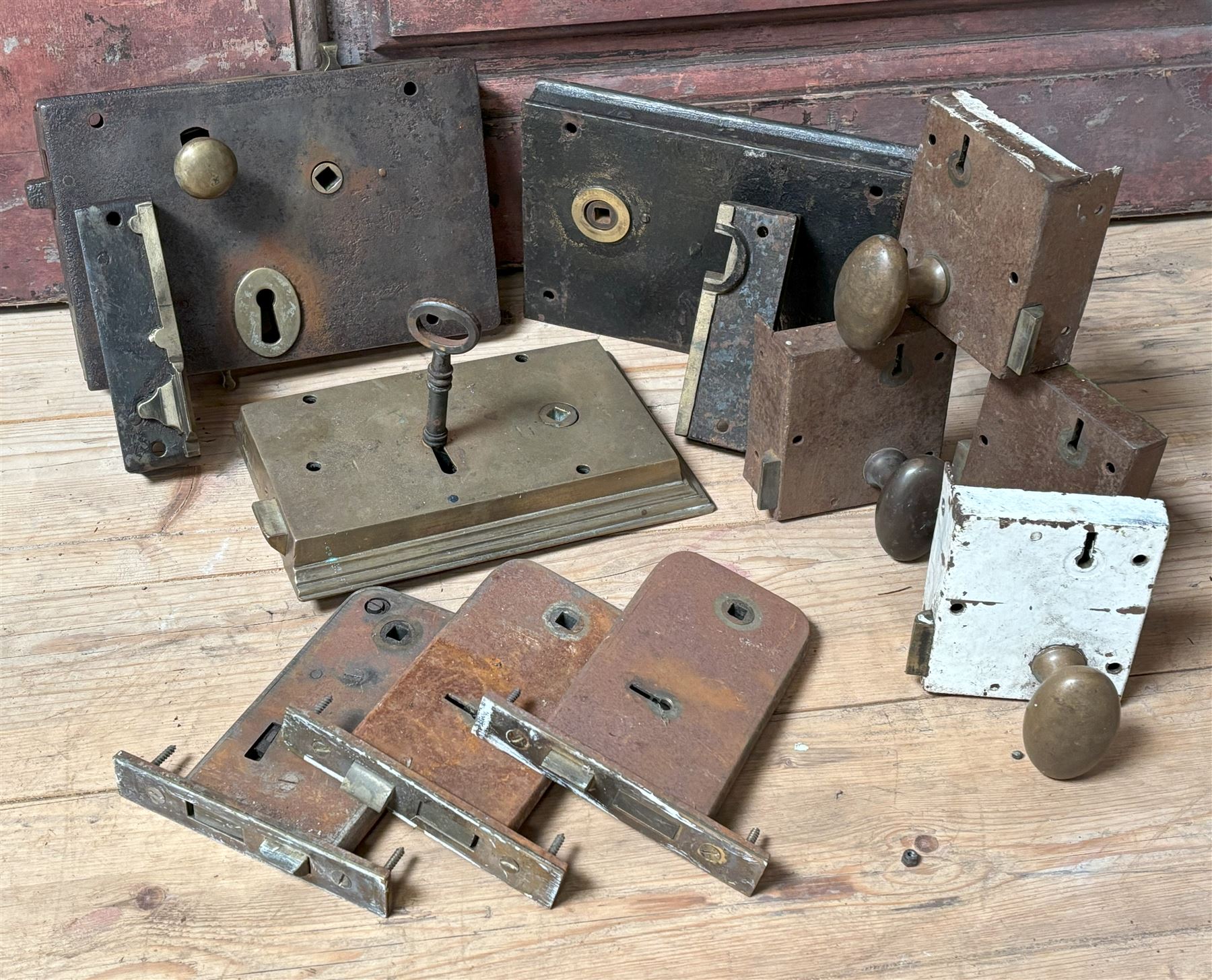 Large Scottish brass rim lock with key, 19th century (W22cm) together with two late Victorian steel cased rim locks with keeps (W23cm) a set of four early 20th century early 20th century surface locks with brass handles, and three mortice locks (10)  - COLLECTION BY APPOINTMENT FROM: The White House, Thirsk Road, Easingwold, York, YO61 3NF - CALL 01723 507111 TO ARRANGE