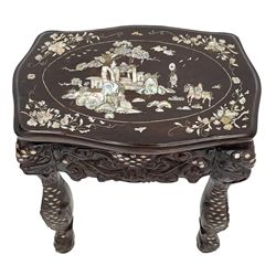 Early 20th century Chinese hardwood stand or side table, the shaped top with mother of pearl inlays depicting traditional landscape scene with figures, carved and pierced friezes with dragon masks, on scaled supports