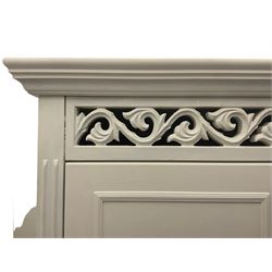 White painted double wardrobe, pierced scrolling foliate frieze over two doors enclosing hanging rail and two shelves, two drawers fitted to base, with blue ceramic handles