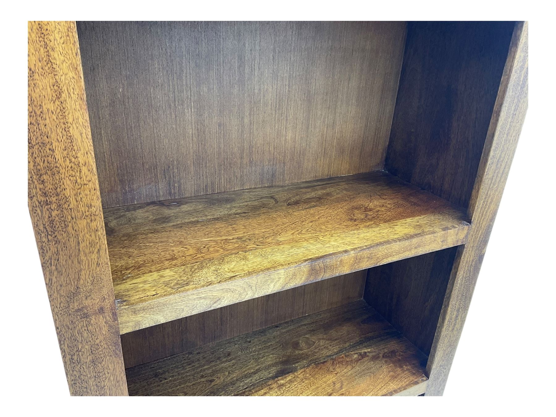 Contemporary Dakota mango wood open bookcase, rectangular form with four fixed open shelves, raised on stile supports