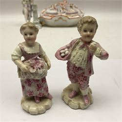 Three Continental figures, comprising a pair modelled as a boy and girl, she with flowers, he with eggs, and a female figure with harp, each probably Volkstedt, together with a Continental porcelain desk stand, (4)