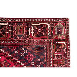 Persian Joshaghan crimson ground rug, stepped lozenge medallion surrounded by repeating foliate lozenge motifs, the border decorated with stylised plant motifs, within geometric guard stripes 