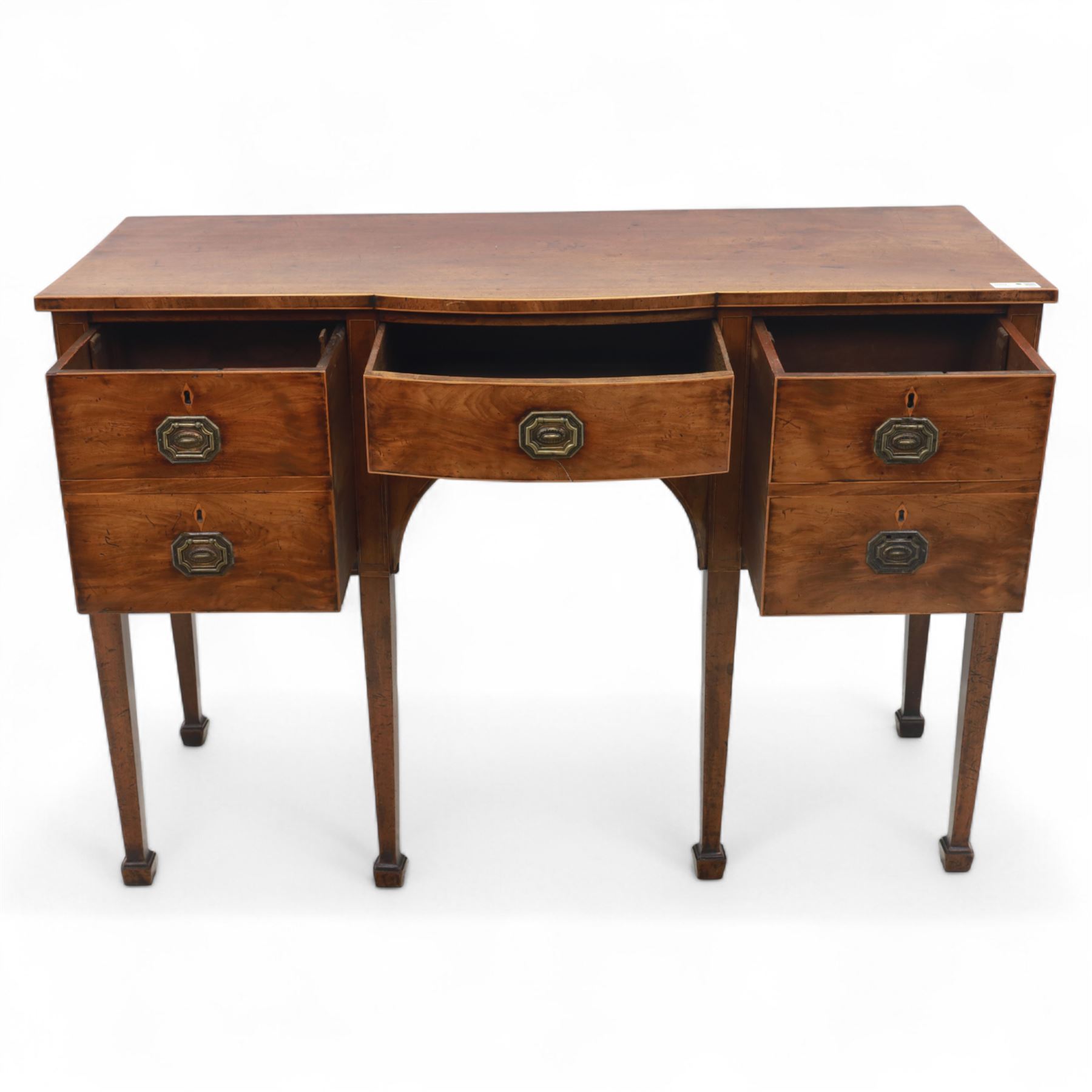 George III Sheraton-style mahogany sideboard, serpentine front fitted with central drawer and flanked by two deep drawers, raised on square tapered legs with spade feet 