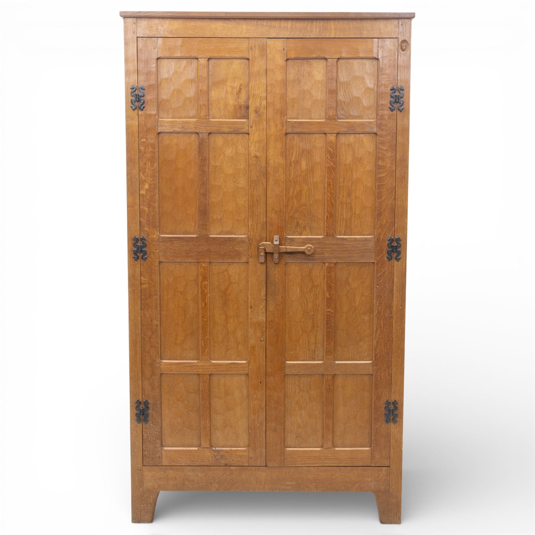 Acornman - oak adzed panelled double wardrobe, with wrought iron hinges and carved oak latch revealing a single clothes rail, with signature carved acorn to top right, by the workshop of Alan Grainger, Brandsby