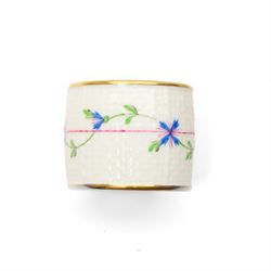 Set of twelve Herend porcelain napkin rings painted with trailing flowers and leaves on a moulded ground