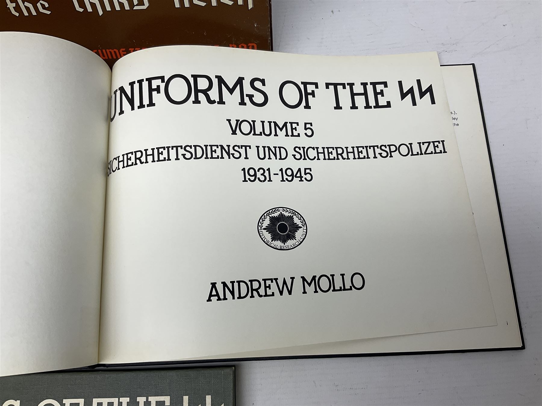 Military Collectors Service: set of three books on WWII German uniforms and badges; and Mollo Andrew: Uniforms of the SS. Volumes 1,4,5,6 & 7 (8)