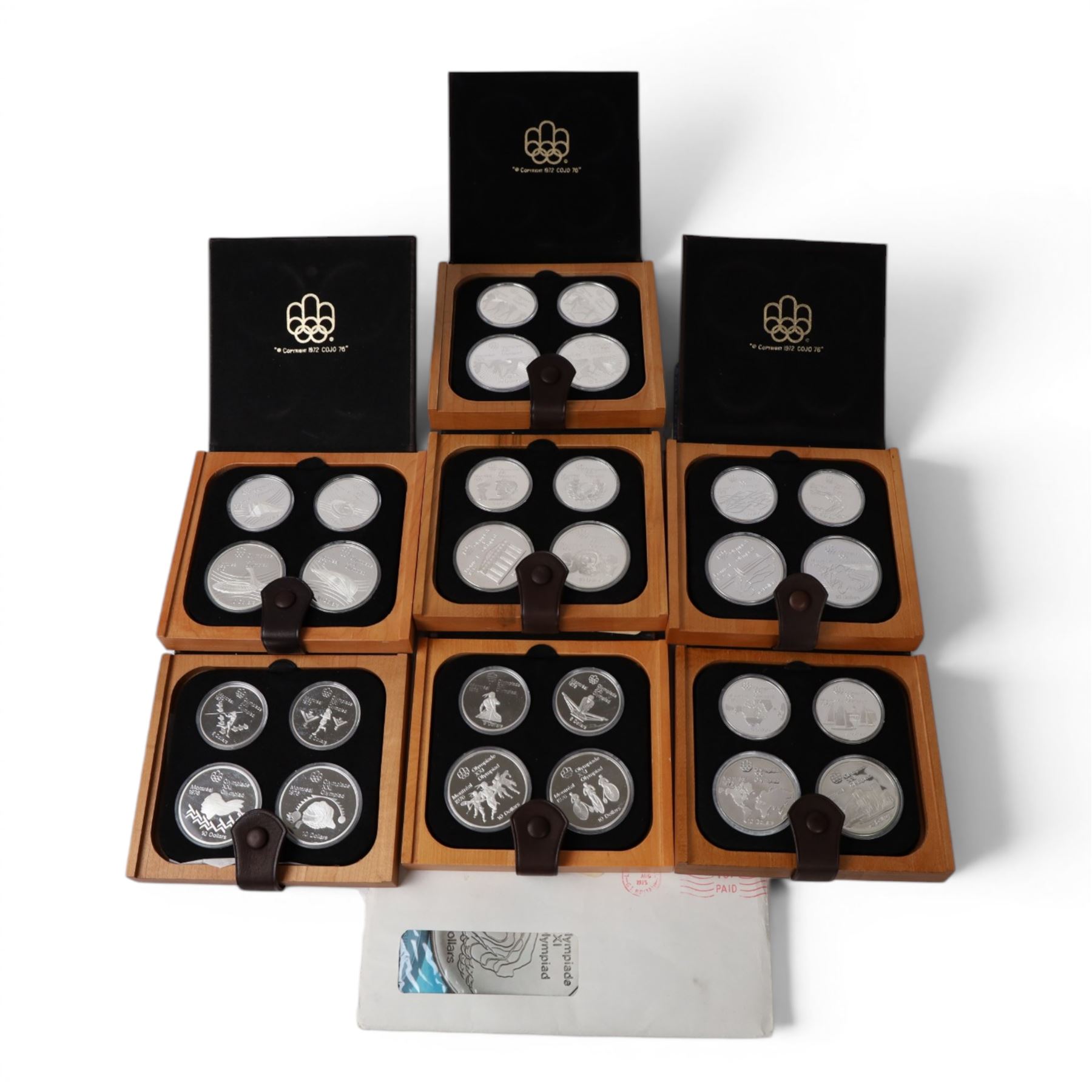Seven Royal Canadian Mint 1976 'Montreal Olympics' silver proof four coin sets, each containing two five dollar and two ten dollar coins, each cased and boxed with certificates