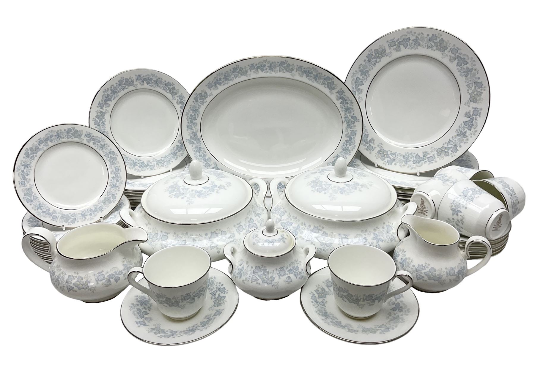Royal Doulton tea and dinner wares in the Meadow Mist pattern, no H5007, comprising seven dinner plates, eight side plates, two lidded tureens, two jugs, lidded sucrier, oval serving dish, six teacups, seven saucers, seven tea plates and large saucer