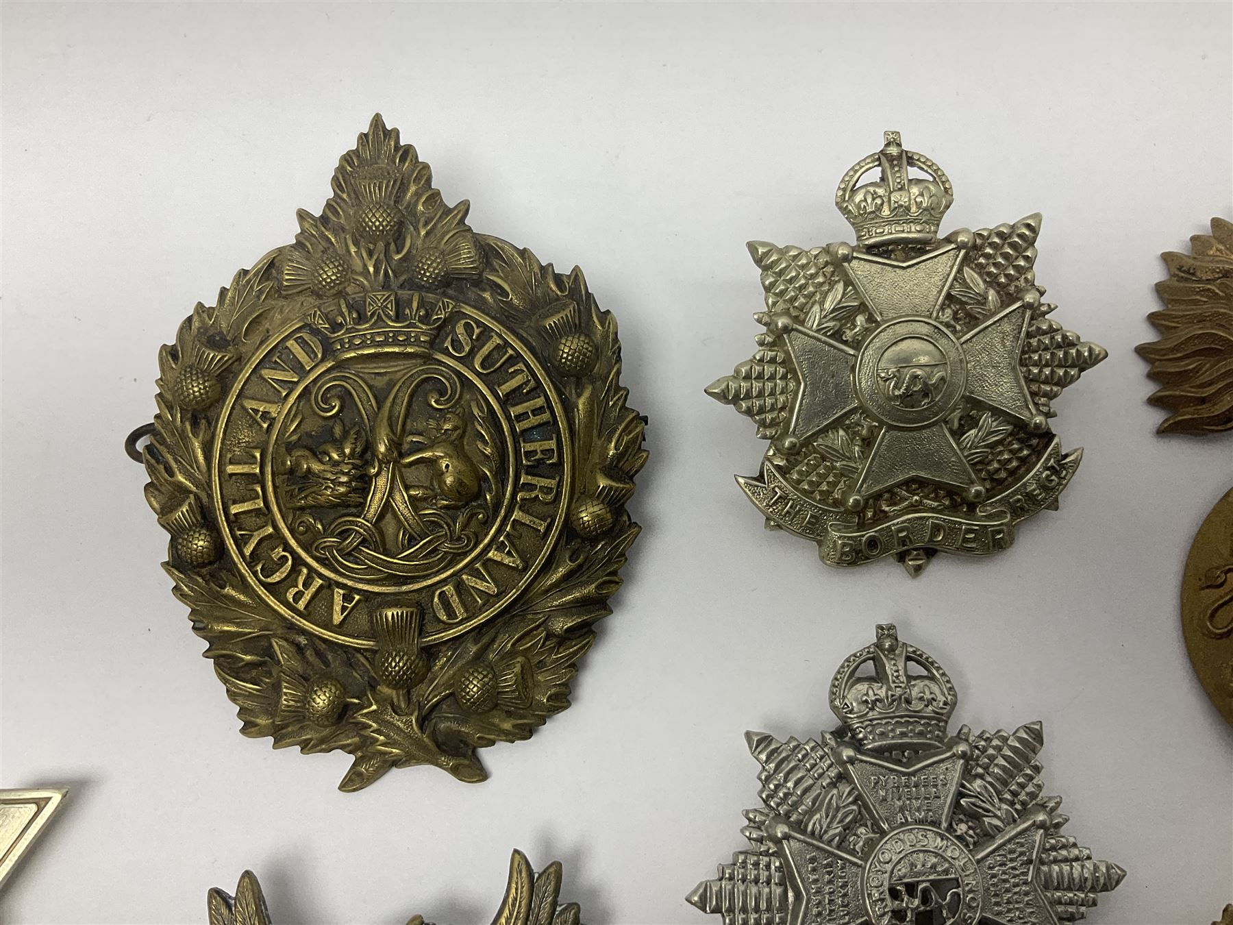 Fifteen Scottish Glengarry and other metal military badges including Argyll & Sutherland, Royal Glasgow Yeomanry, Cameronians, Lanarkshire Yeomanry, Kings Scottish Own Borderers, Highland Light Infantry, Border Regiment, Lowland Regiment, Lothians & Border Horse Yeomanry, Ayrshire Earl of Carricks Own Yeomanry etc