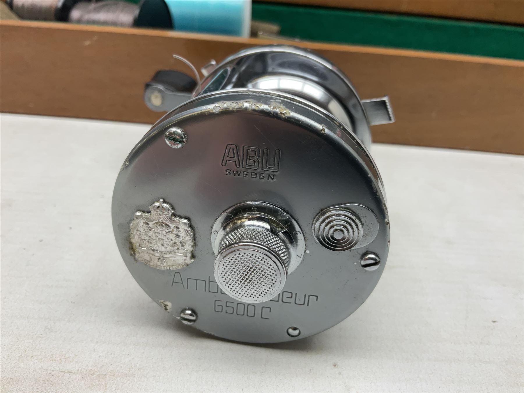 Four Abu fishing reels, comprising Ambassadeur 9000, Ambassadeur 7000, Ambassadeur 5500 and Ambassadeur 6500, together with additional line, hardy fishing bag and two wooden boxes