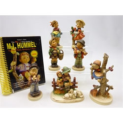  Six Goebel Hummel figures 'Serenade', 'Out of Danger', 'Village Boy', 'Bashful', 'Little Fiddler' & 'Eventide' with a similar style figure and a Hummel Guide book (7)  