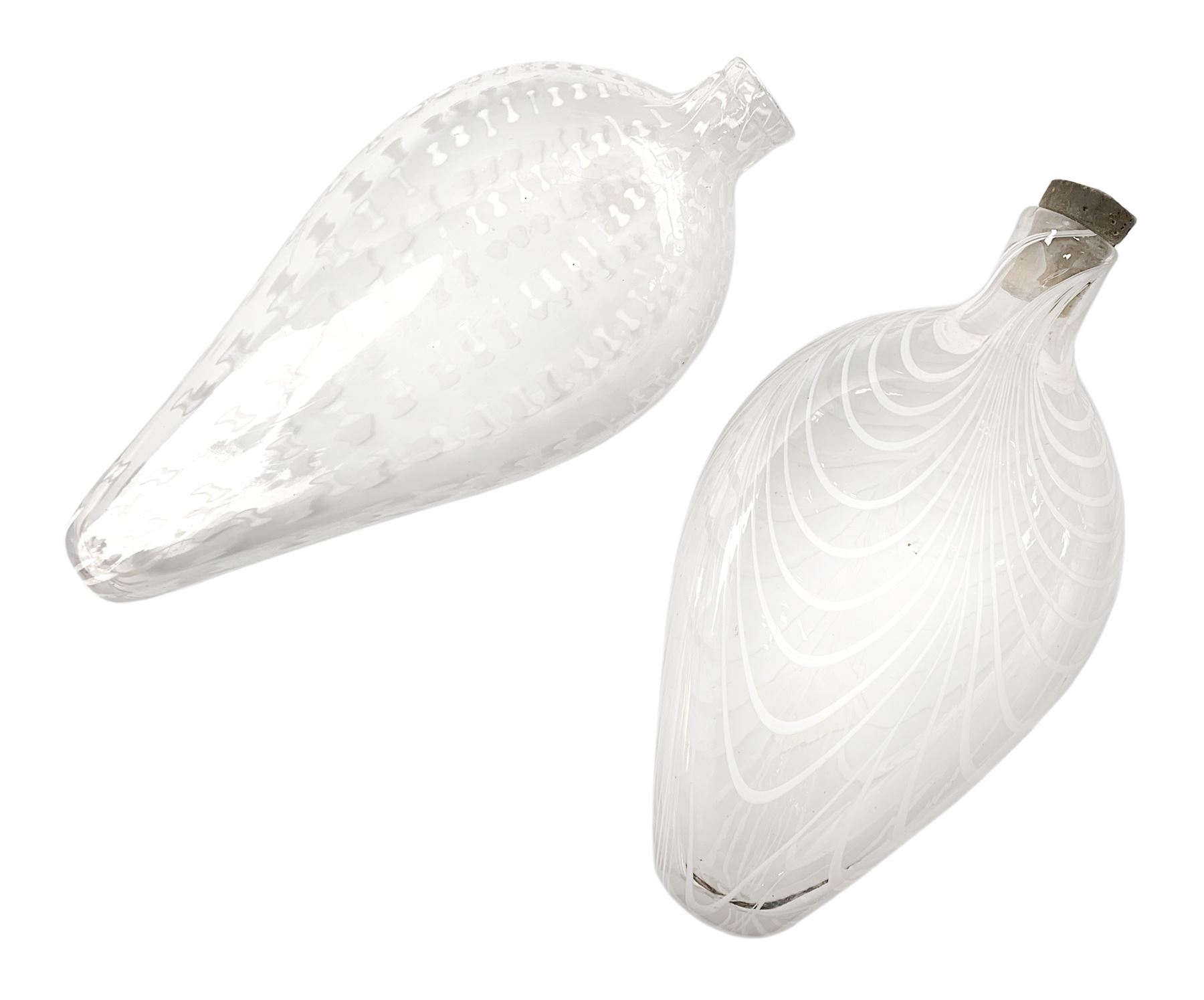 19th century Nailsea glass flask of compressed ovoid form, the clear body with opaque white combed decoration, H21cm, together with another similar example decorated with enamelled stylised bands, H23cm