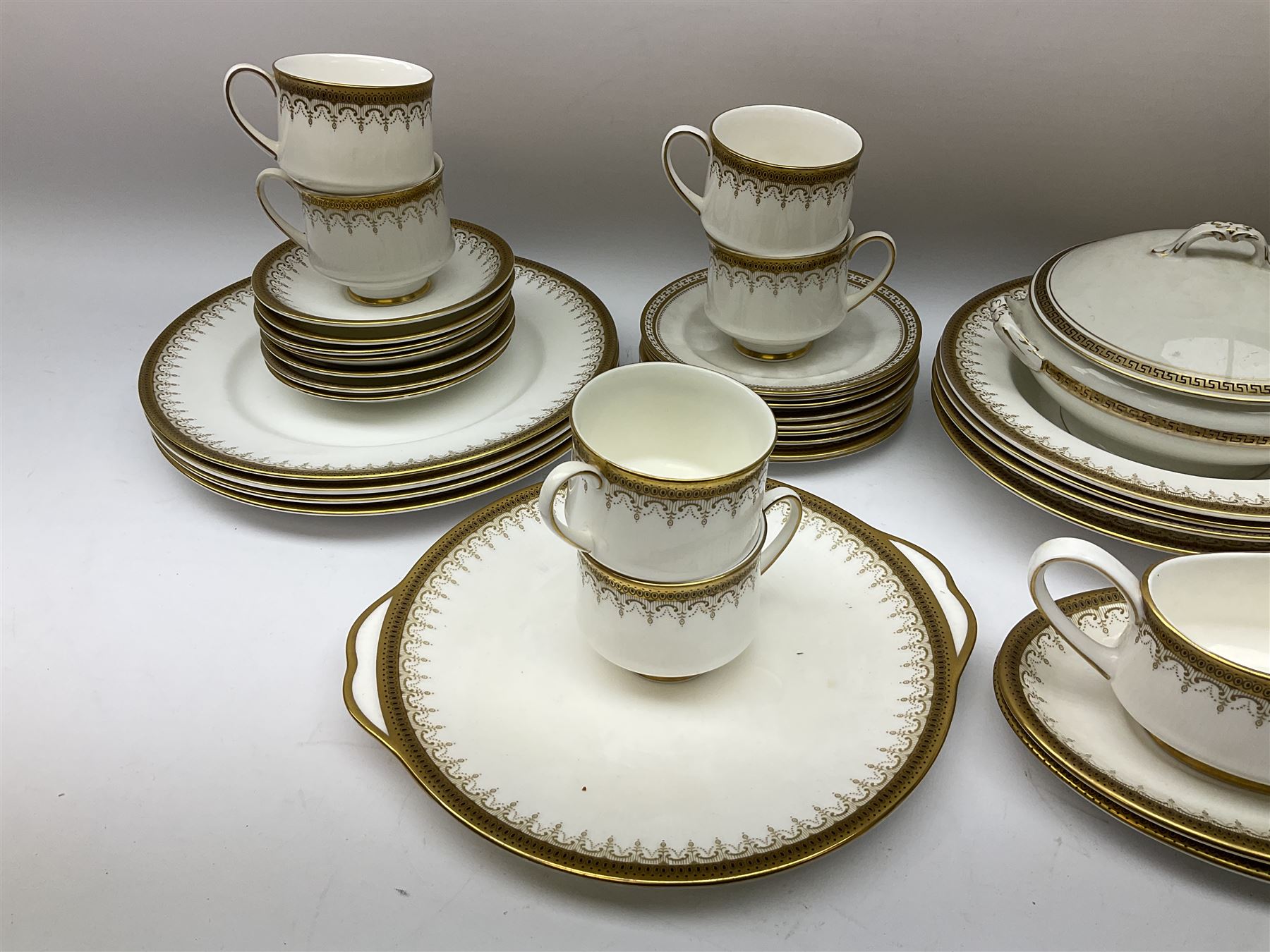 Paragon and Royal Albert tea and dinner wares in Athena pattern, including fifteen cups and saucers, gravy boat and saucer, four dinner plates, four soup bowls etc (52), together with three spode tea plates in golden bracelet pattern and another tureen with ladle in similar design. 