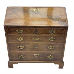 George III mahogany bureau, fall-front enclosing a fitted interior of drawers, pigeonholes and central mirrored cupboard, over four graduated cockbeaded drawers with brass batwing handles, raised on bracket feet