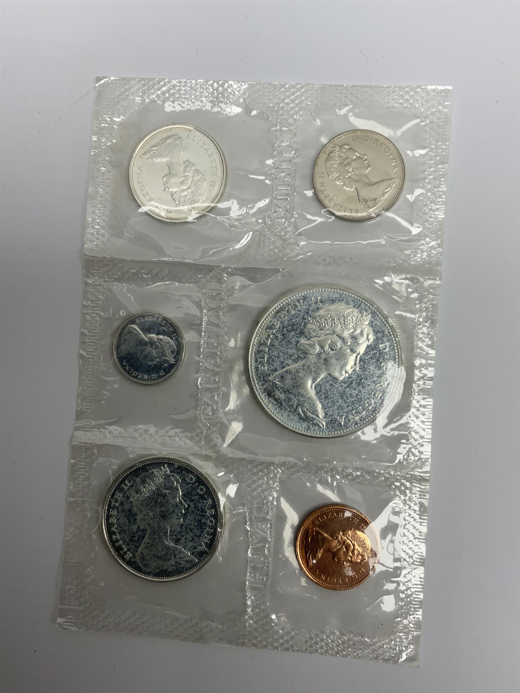Mostly Canadian coins including 1967 six coin set, various Canadian 50 cent coins, various nickels, Royal Canadian Mint 1990 specimen coin set in blue folder with outer sleeve, various Canadian dollars etc, in folders and loose