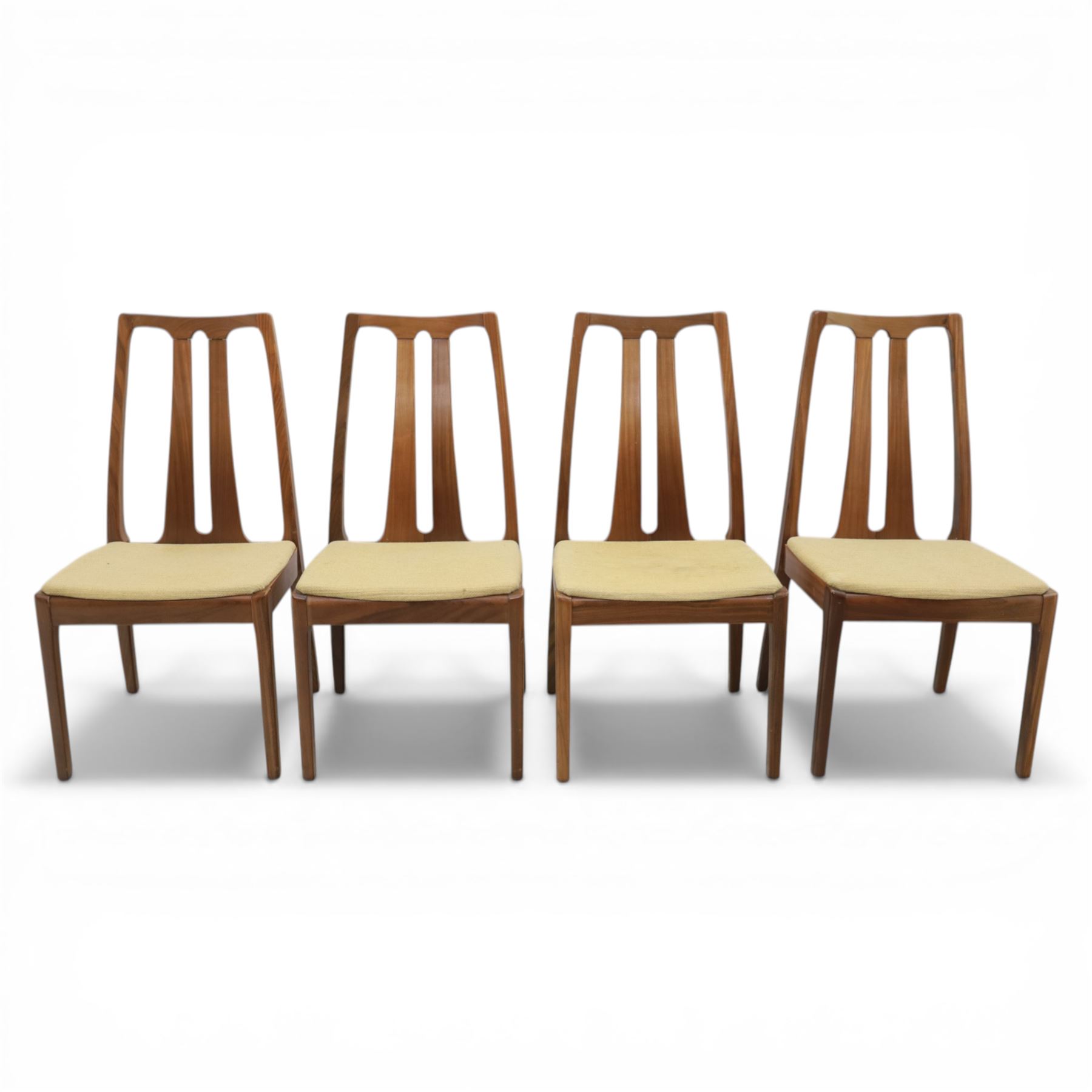 Nathan - teak drop leaf dining table and four Nathan dining chairs, the rectangular top with rounded corners fitted with twin hinged drop leaves and gate legs, extended to form an oval table 174cm in length, raised on square section supports united by stretchers, the chairs with teak frames and padded beige upholstered seat (H 96cm, W 48cm)