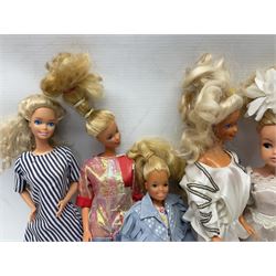 Eleven 1980s fashion dolls, predominantly Barbie/Ken, all dressed; together with some additional clothing.