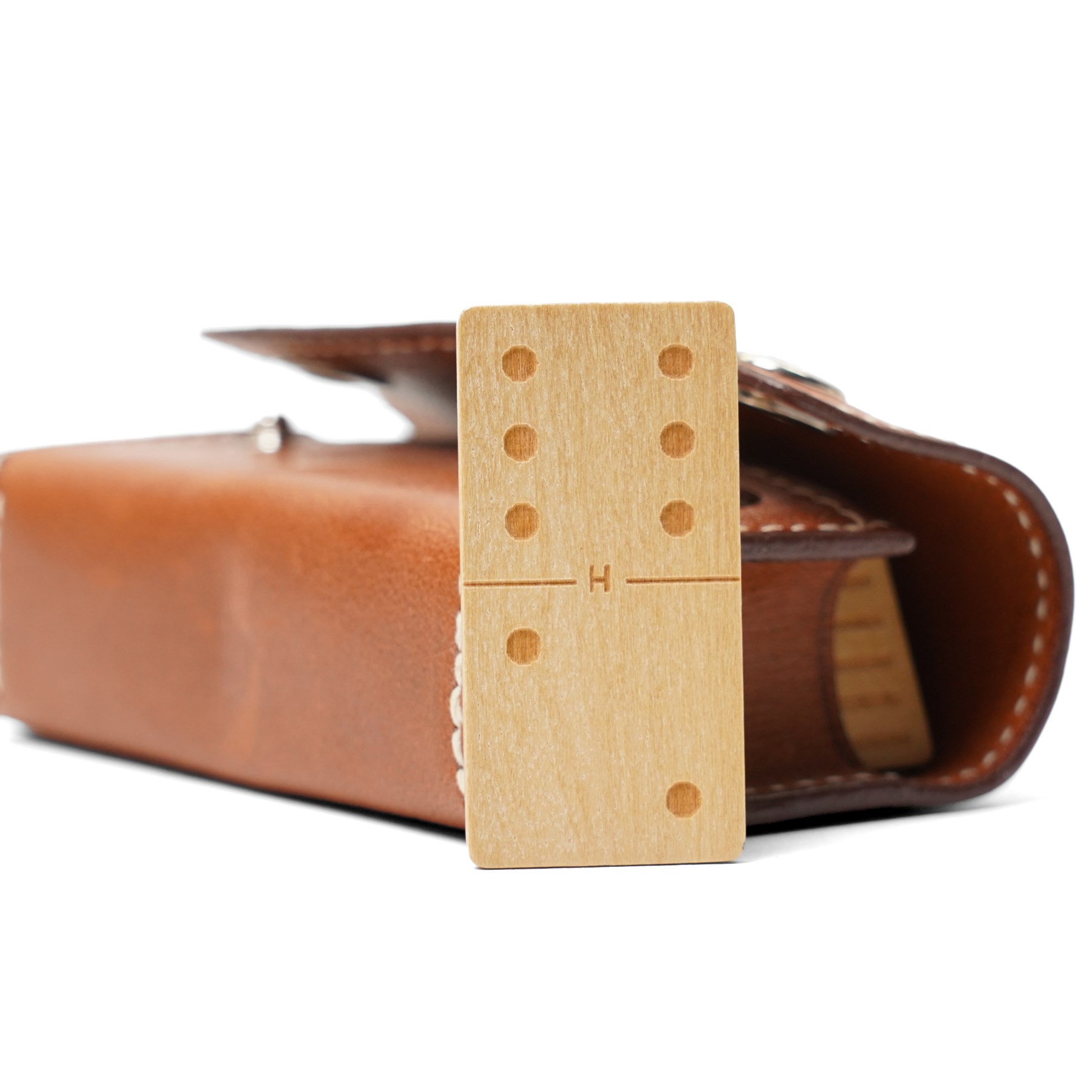Hermès - ‘Mini-Dominos In-the-Pocket’ game, comprising miniature domino set in tan leather press-stud case, with original box and booklet