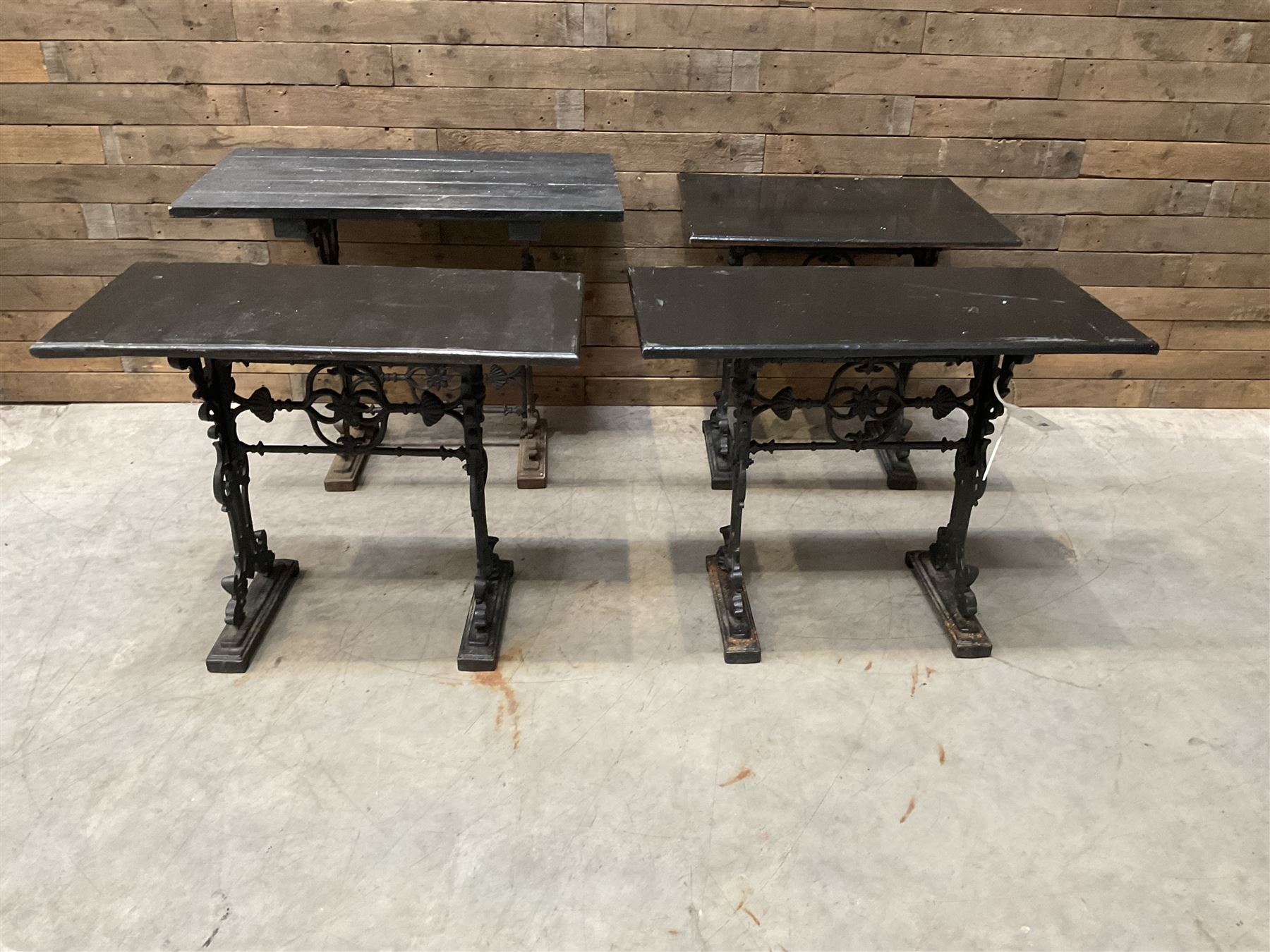 Four cast iron pub or bar tables with rectangular tops