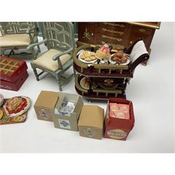 Collection of miniature dolls house furniture, to include display cabinet with pink and white floral dinner service, two serving trolleys with cakes and sweets and two blue painted kitchen dressers, together with miniature dolls house cardboard food packaging and animal figures including dogs and cats, etc