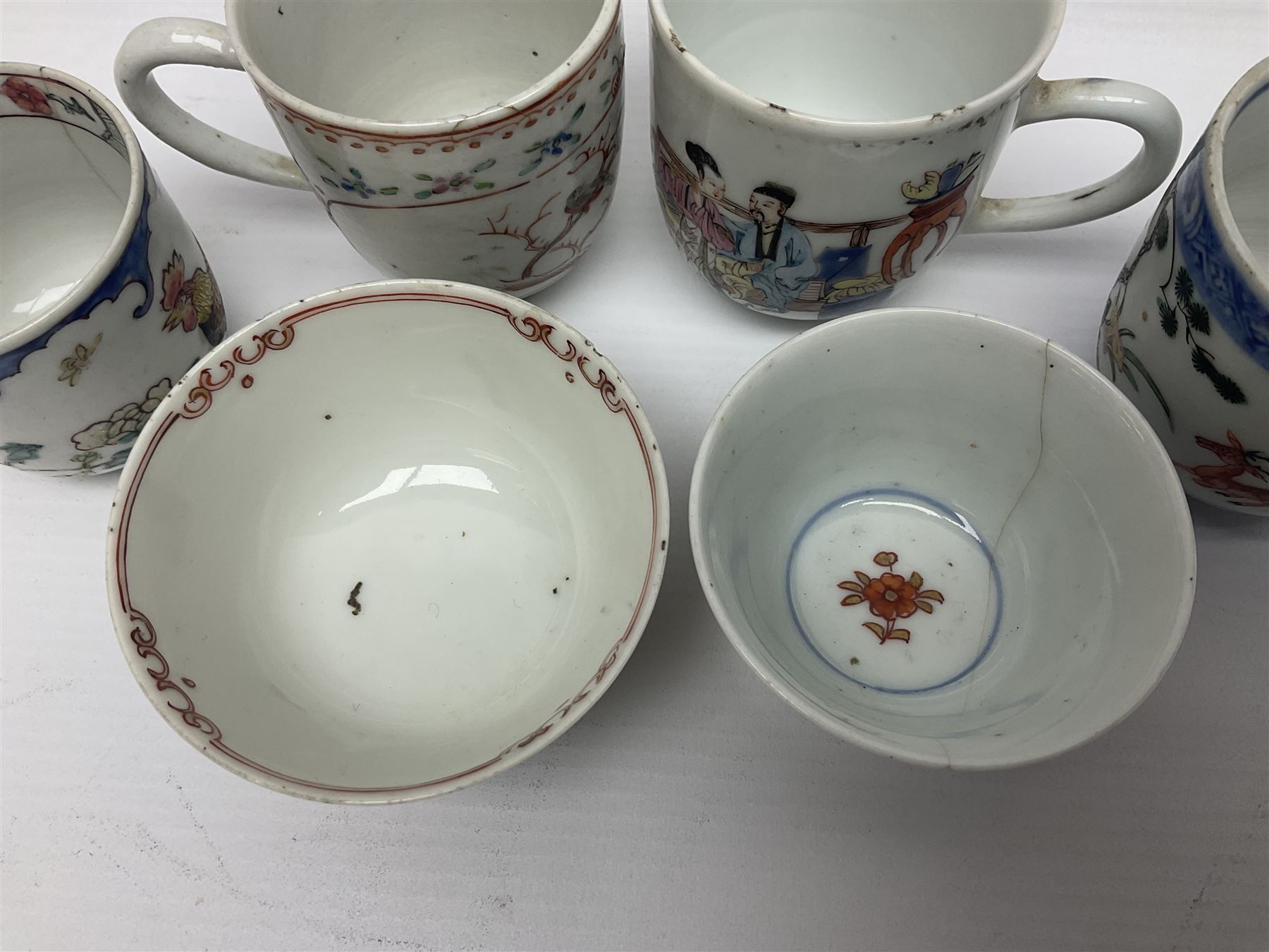 Two 18th century Chinese Yongzheng coffee cups, the first example decorated in polychrome enamel with rooster amidst blossoming peonies, the second decorated with deer and crane among rockwork and pine tree, together with two further 18th century Chinese coffee cups, an 18th century Chinese tea bowl, and a further tea bowl